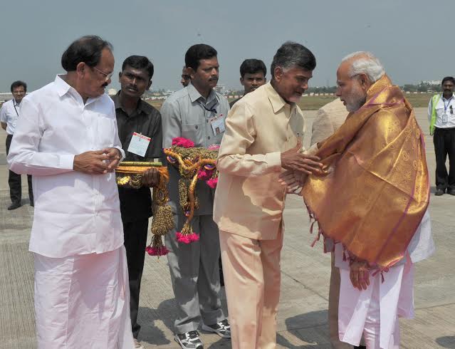  Narendra Modi being welcomed on arrival by the Chief Minister of Andhra Pradesh