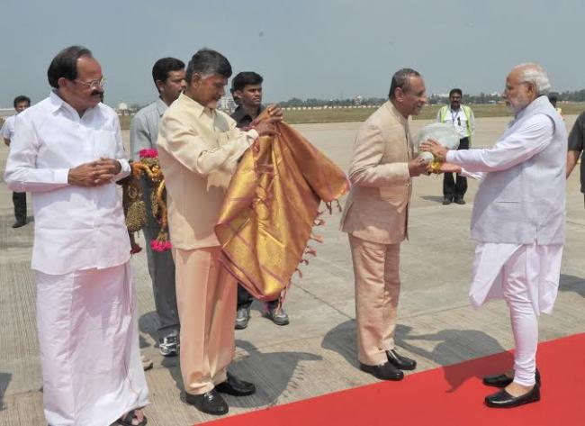  Narendra Modi being welcomed on arrival by the Chief Minister of Andhra Pradesh