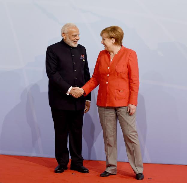 Narendra Modi being welcomed by the German Chancellor