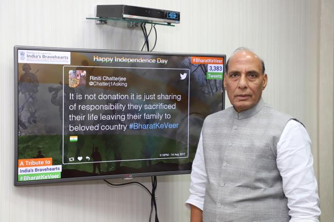 Rajnath Singh presenting a cheque to the Union Home Secretary