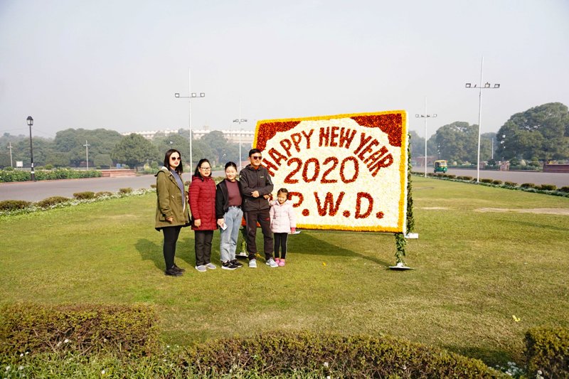 Tourists pose for photograph in New Delhi