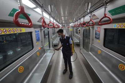 Lucknow Metro employee sprays disinfectants inside coaches at Hazratganj station
