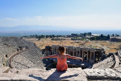 Turkey: A visitor sits on the ruins of the ancient city of Hierapolis