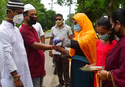 Muslim girls tying Rakhi