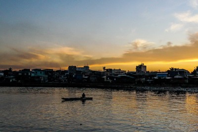Fisherman prepares to sail on his boat in Manila Bay