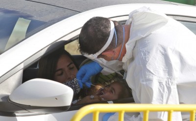 Medical worker taking swab sample from a girl in Israel