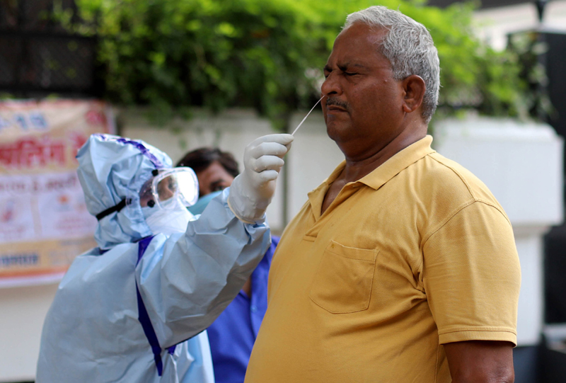 Prayagraj: Health worker collects swab