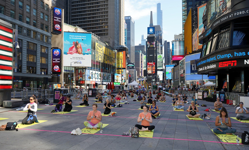 People practicing Yoga at Times Square