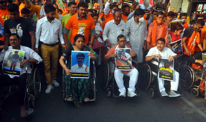 BJP workers in a 'Wheelchair Tribute March' attacking West Bengal CM Mamata Banerjee