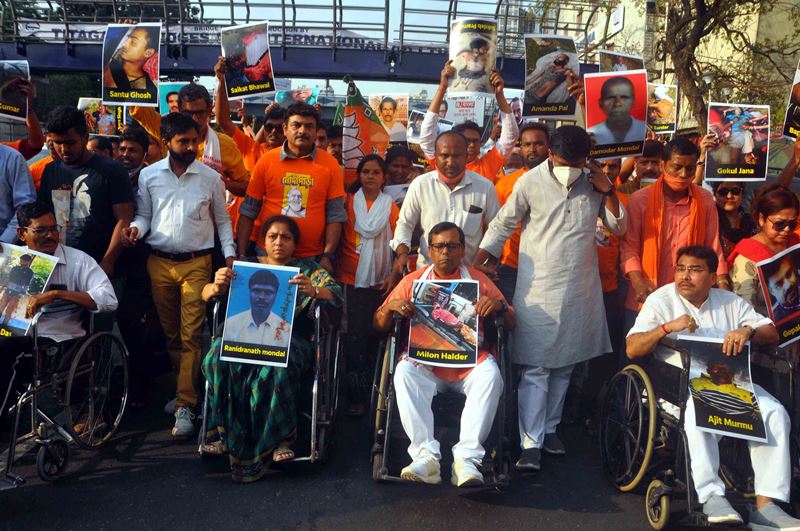 BJP workers in a 'Wheelchair Tribute March' attacking West Bengal CM Mamata Banerjee