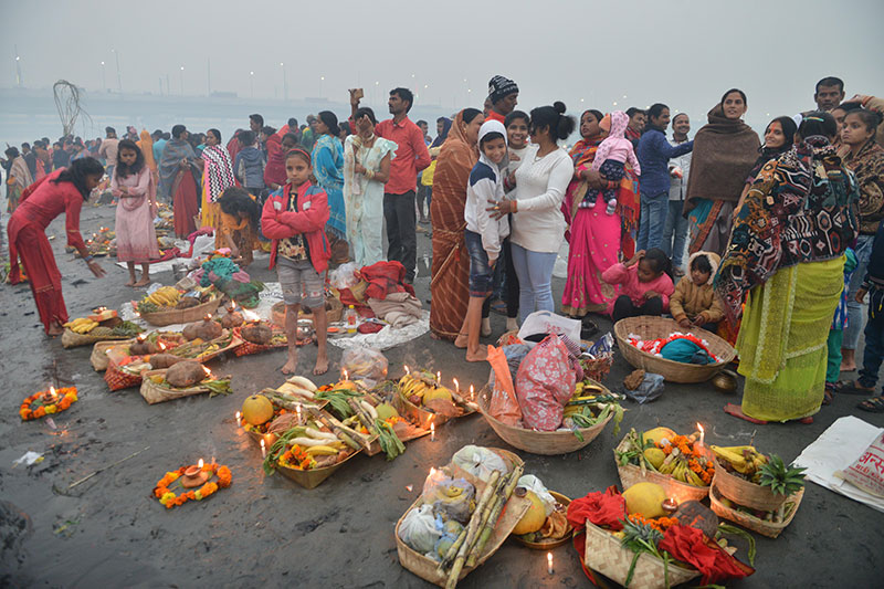 Devotees worship the rising sun at the banks of Yamuna in Delhi