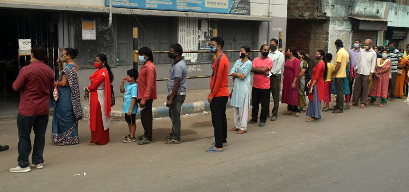Voters waiting in queue at Thakurpukur polling station in Kolkata during Bengal Assembly Elections