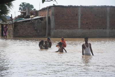 People braving floodwaters in a village near Patna