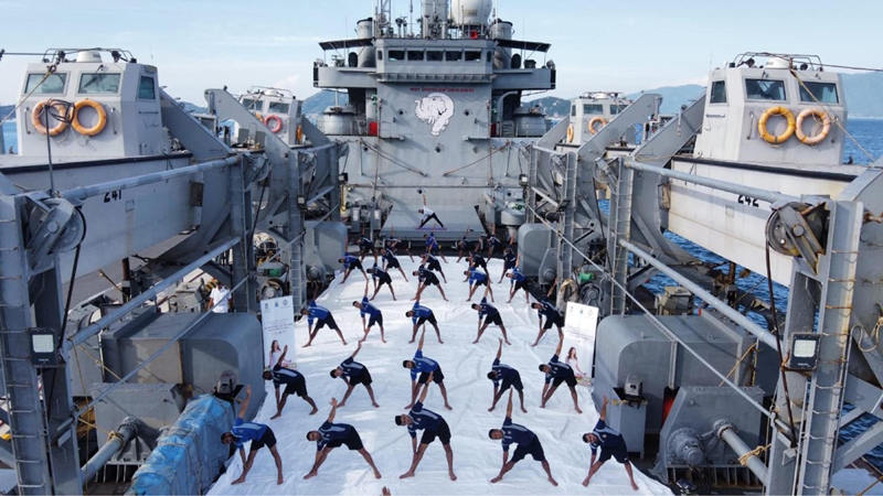 Indian Navy personnel practicing Yoga onboard INS Airavat