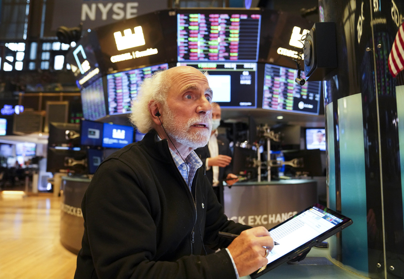 Traders work at the trading floor in the New York Stock Exchange