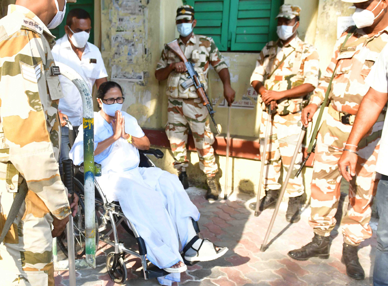Mamata Banerjee sports a victory sign after casting her vote today