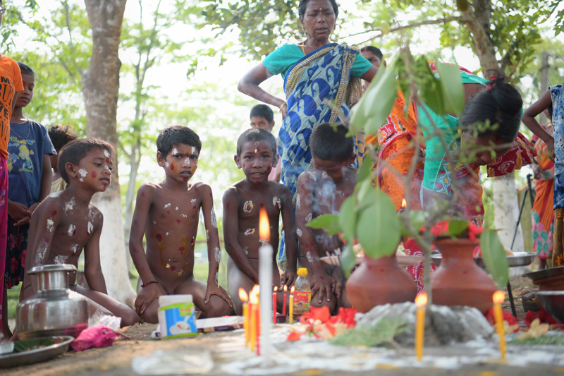 Workers of Durgabari Tea Garden in Agartala hold a pair of frogs in prayers for rain