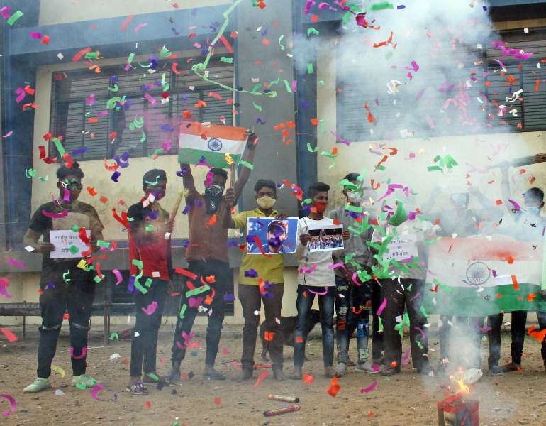 People in India celebrate India's historic win in Australia