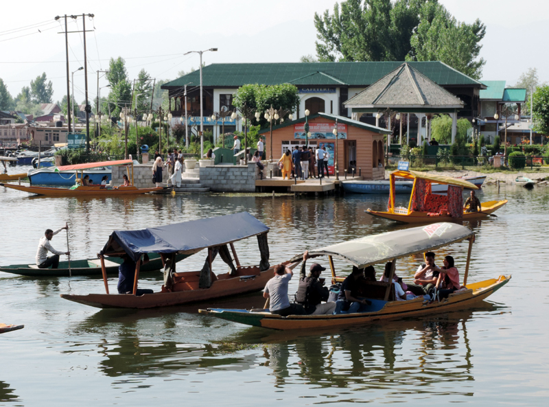 Tourists taking a shikara ride in Srinagar's Dal Lake