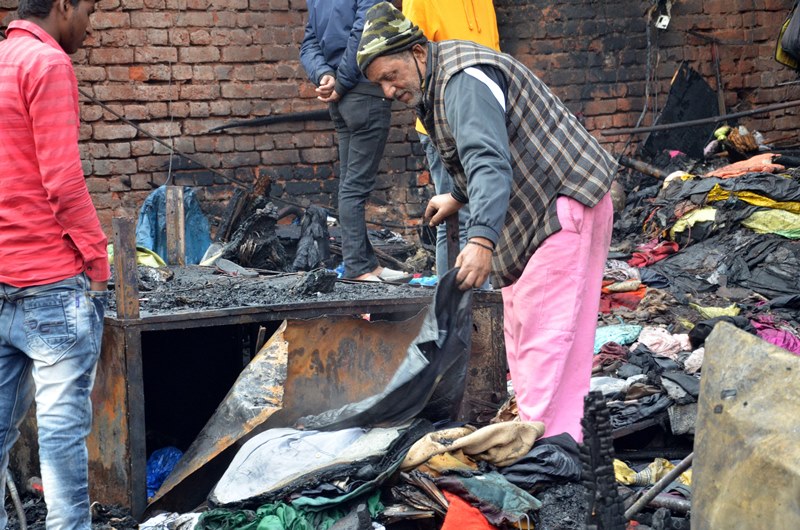 Firefighters extinguishing fire at Delhi's Lajpat Rai market