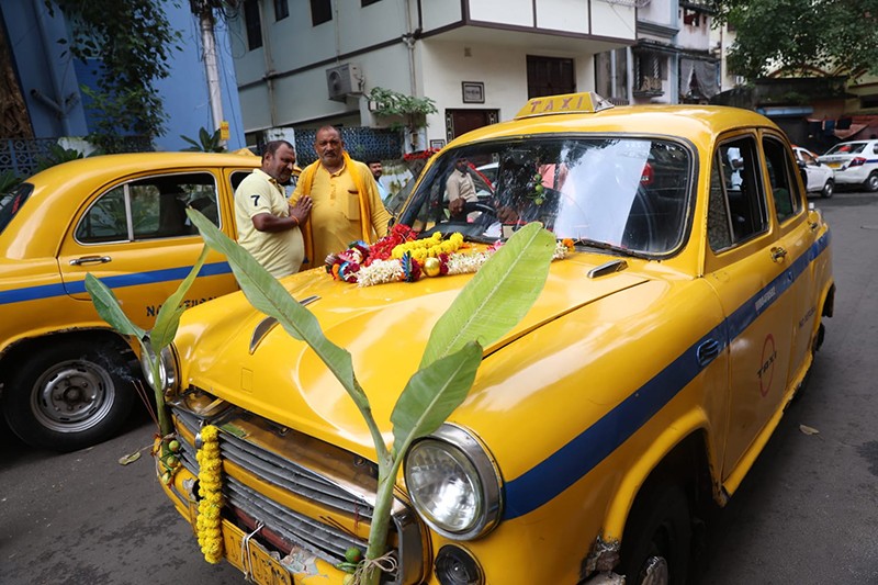 Priest offers prayers to taxi during Vishwakarma Puja in Kolkata