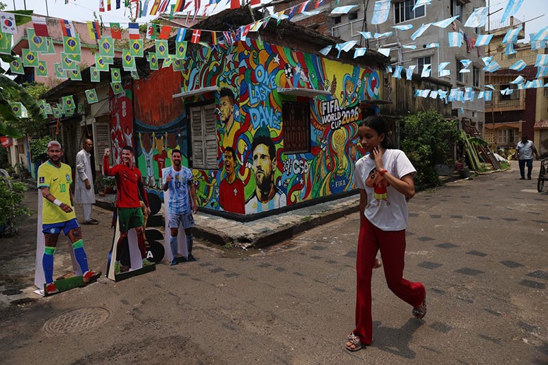 In Images: Children in Kolkata play against the backdrop of a giant World Cup masterpiece