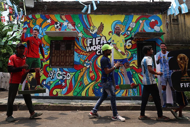 In Images: Children in Kolkata play against the backdrop of a giant World Cup masterpiece