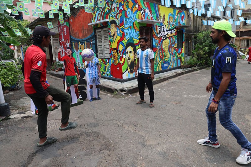 In Images: Children in Kolkata play against the backdrop of a giant World Cup masterpiece