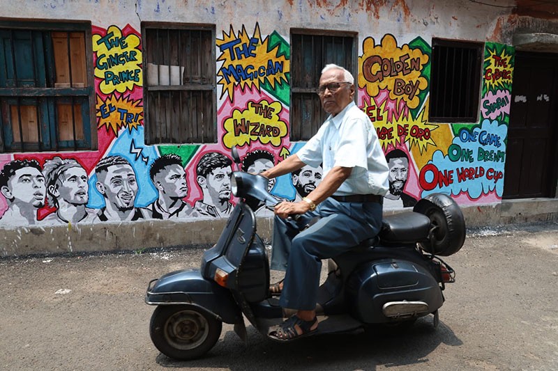 In Images: Children in Kolkata play against the backdrop of a giant World Cup masterpiece