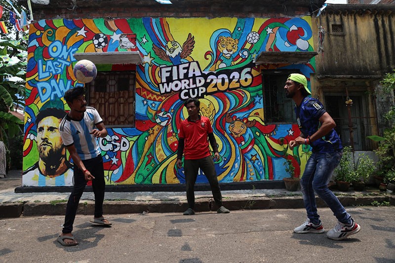 In Images: Children in Kolkata play against the backdrop of a giant World Cup masterpiece