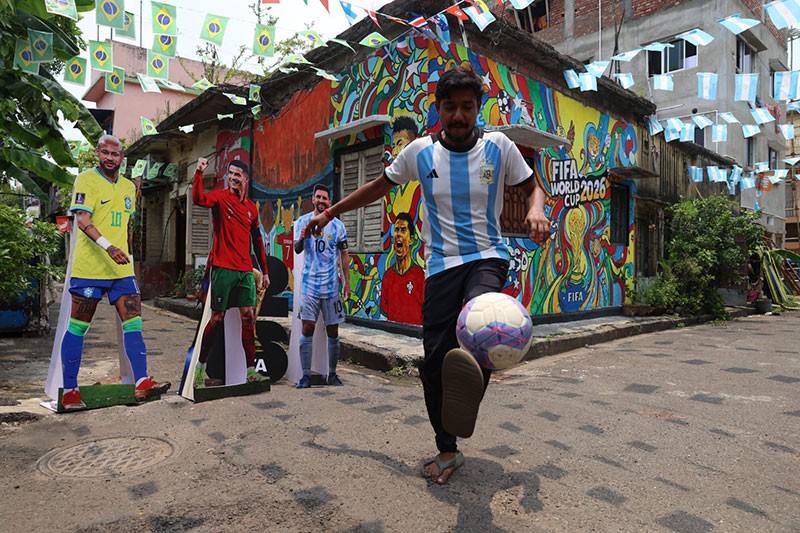 In Images: Children in Kolkata play against the backdrop of a giant World Cup masterpiece
