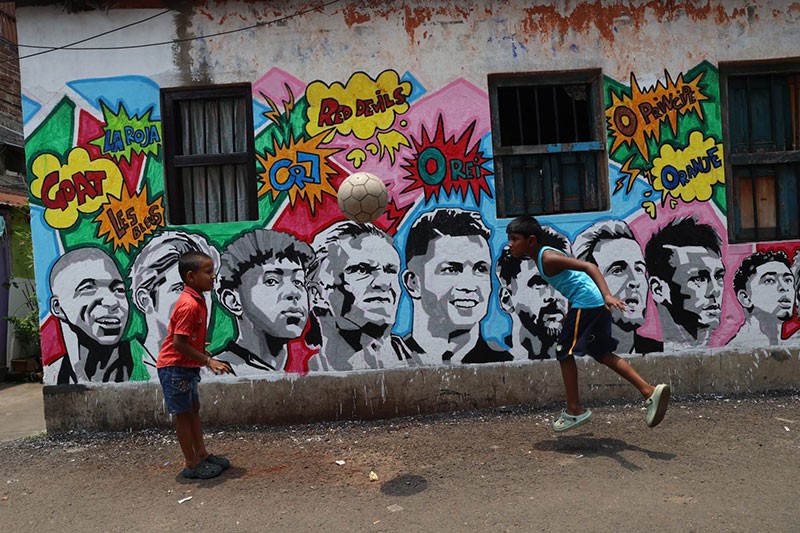 In Images: Children in Kolkata play against the backdrop of a giant World Cup masterpiece