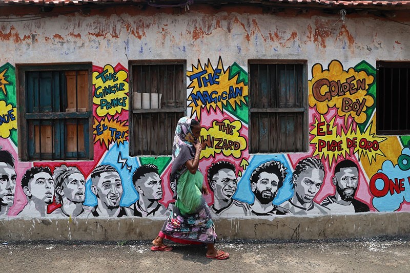 In Images: Children in Kolkata play against the backdrop of a giant World Cup masterpiece