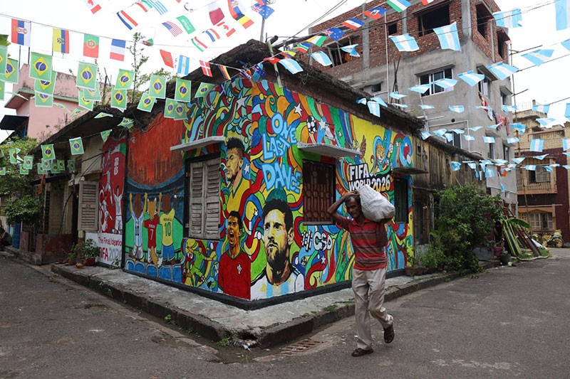 In Images: Children in Kolkata play against the backdrop of a giant World Cup masterpiece