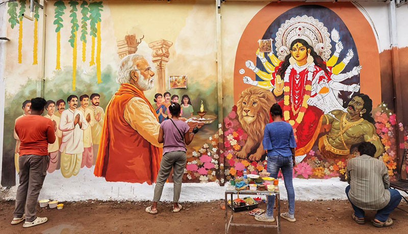 In Images: Kolkata’s Chorebagan Sarbojonin unveils wall painting of PM Modi performing aarti to Goddess Durga