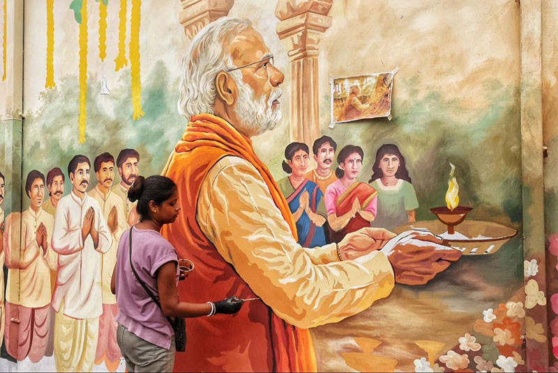 In Images: Kolkata’s Chorebagan Sarbojonin unveils wall painting of PM Modi performing aarti to Goddess Durga